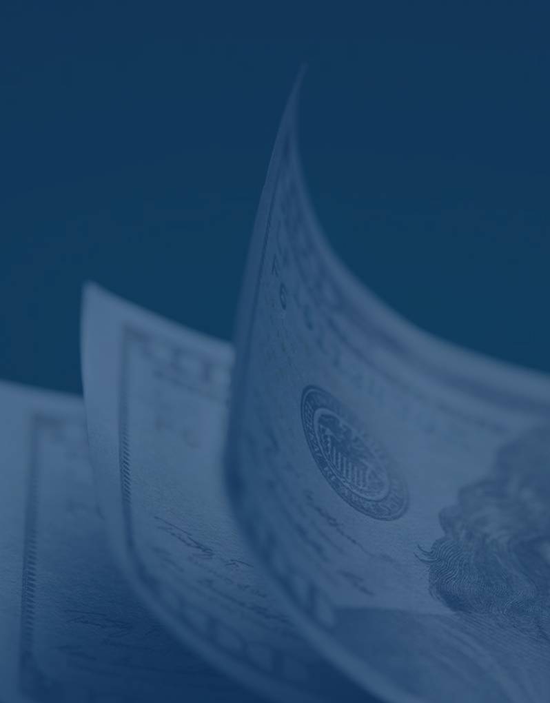 Close-up of a rolled US dollar bill with a blue tint.