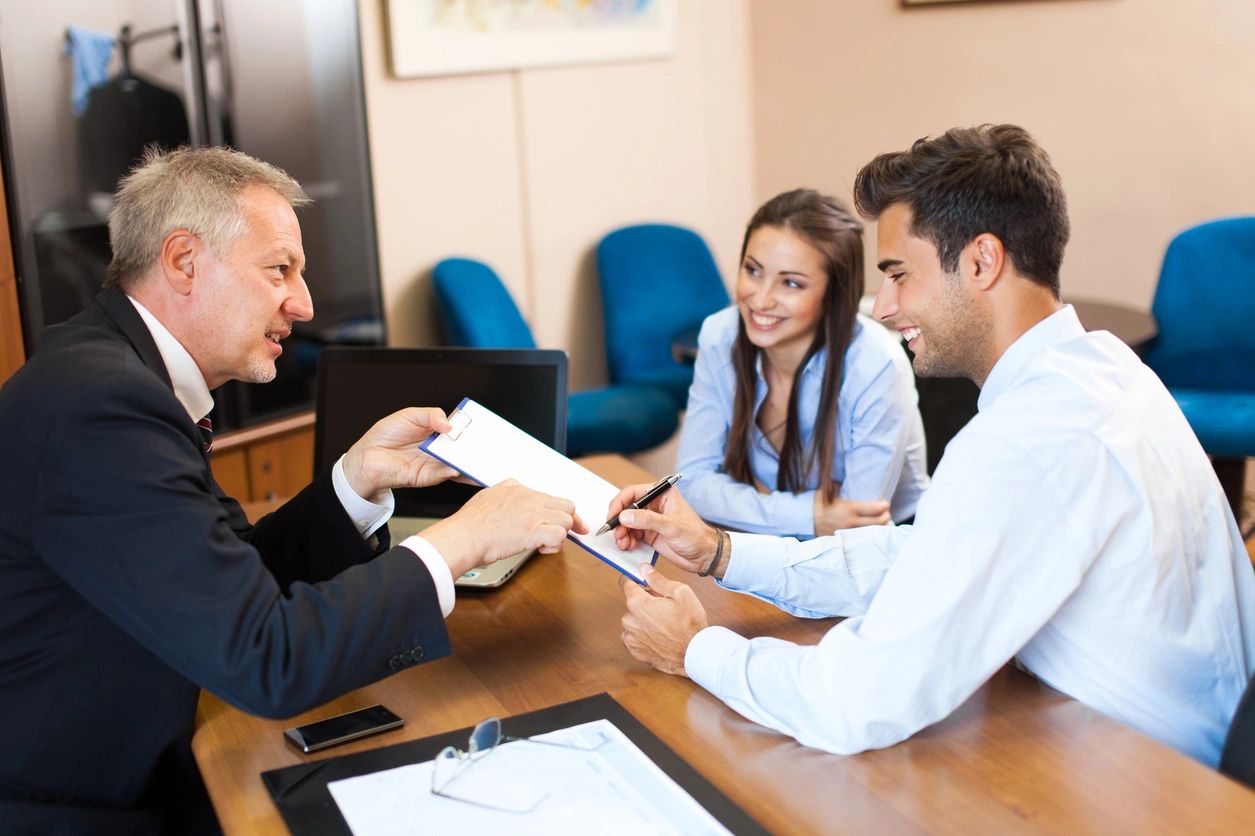 Couple consulting a professional in an office setting.